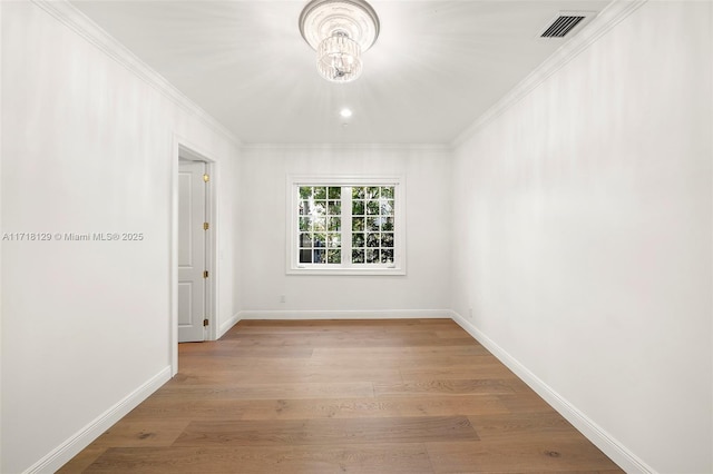 unfurnished room with light hardwood / wood-style floors and crown molding