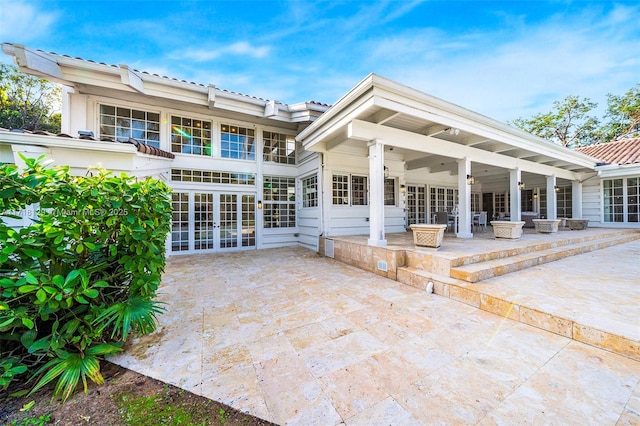 rear view of house with a patio area and french doors