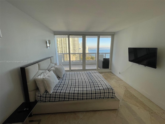 bedroom with access to exterior and floor to ceiling windows