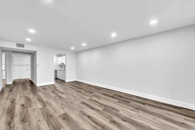 unfurnished bedroom with wood-type flooring and sink