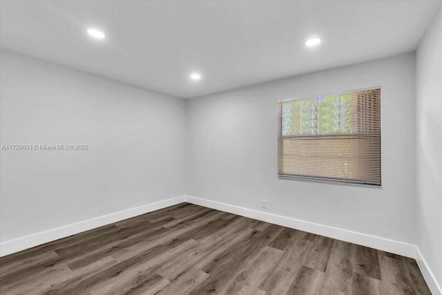 unfurnished room with wood-type flooring