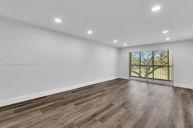 unfurnished room featuring dark hardwood / wood-style floors