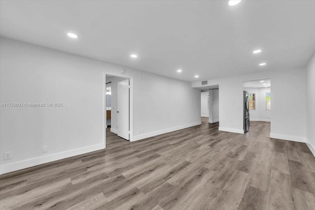 unfurnished living room with hardwood / wood-style floors