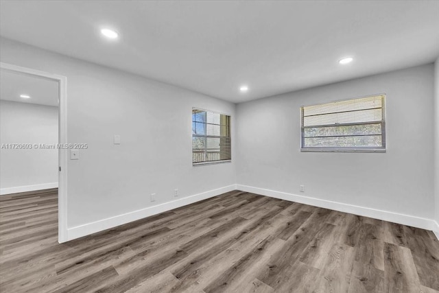 unfurnished room with a wealth of natural light and wood-type flooring