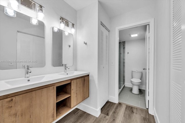 bathroom featuring hardwood / wood-style floors, vanity, and toilet