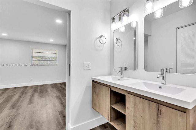 bathroom with vanity and wood-type flooring