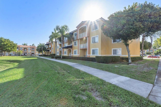 view of property's community with a lawn