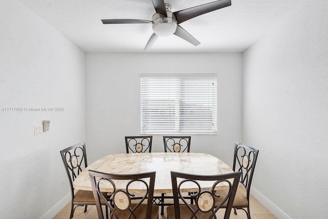 dining area featuring ceiling fan and light tile patterned flooring