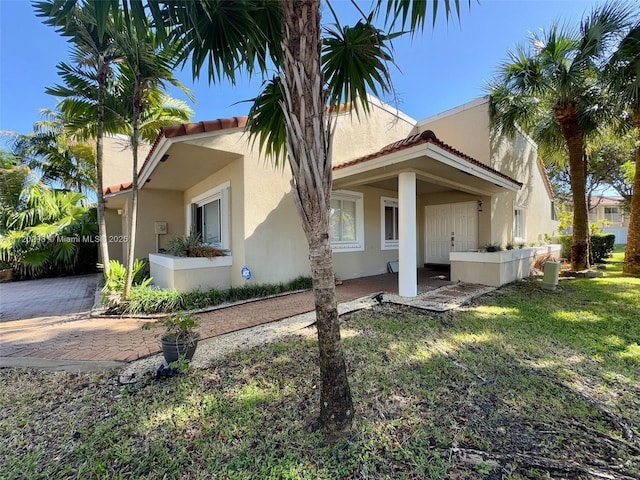 mediterranean / spanish-style home featuring a front lawn