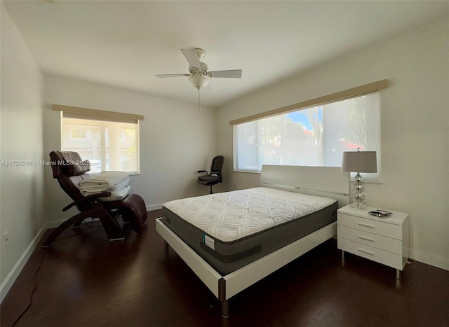 bedroom with ceiling fan and dark wood-type flooring