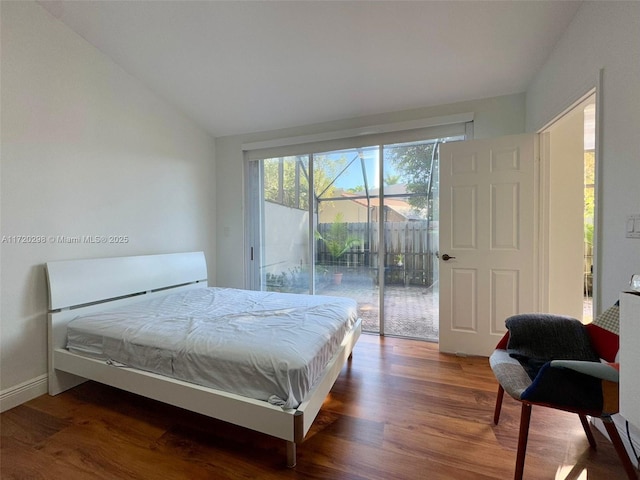 bedroom with hardwood / wood-style floors and access to outside