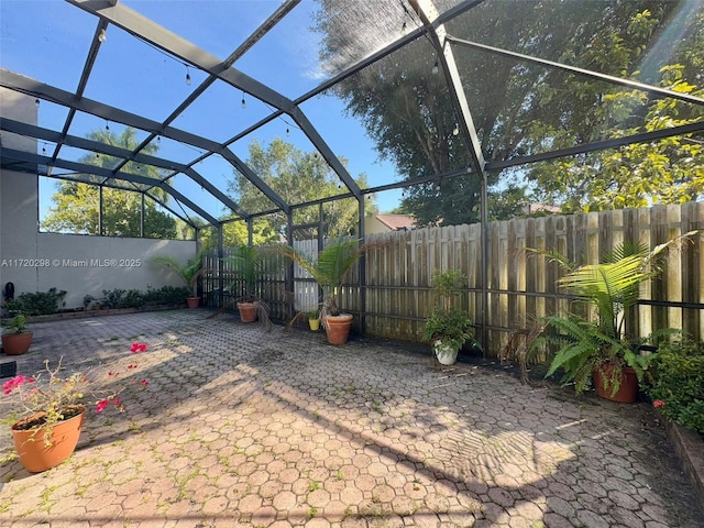 view of patio with glass enclosure