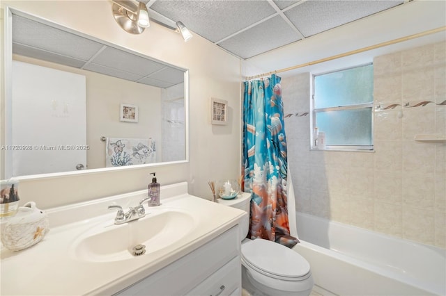 full bathroom with vanity, shower / tub combo, a paneled ceiling, and toilet