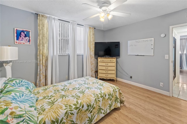 bedroom with hardwood / wood-style floors and ceiling fan