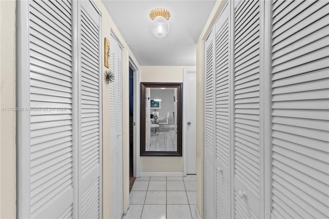 hall featuring light tile patterned floors