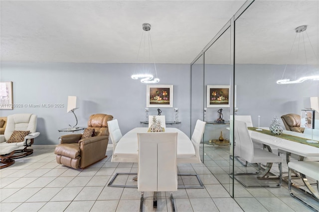 tiled dining area with a chandelier