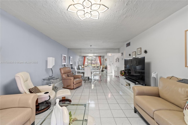 living room featuring light tile patterned floors and a textured ceiling