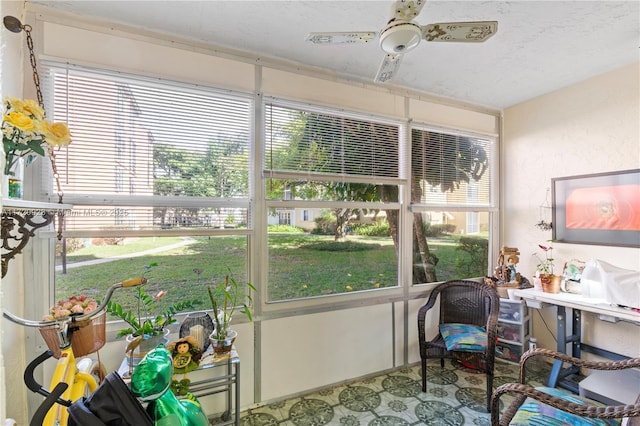 sunroom featuring ceiling fan