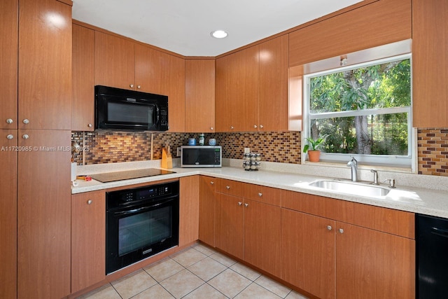 kitchen with black appliances, light tile patterned flooring, sink, and tasteful backsplash