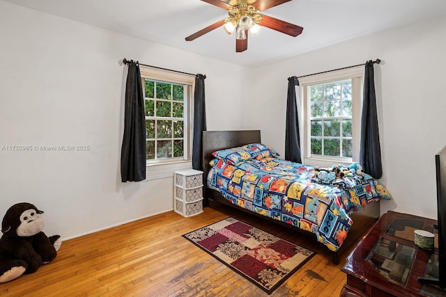 bedroom with ceiling fan and light wood-type flooring