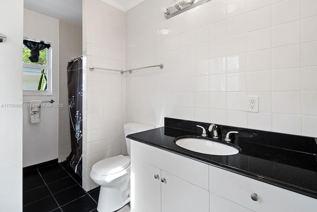 bathroom featuring tile patterned flooring, toilet, vanity, tile walls, and ornamental molding