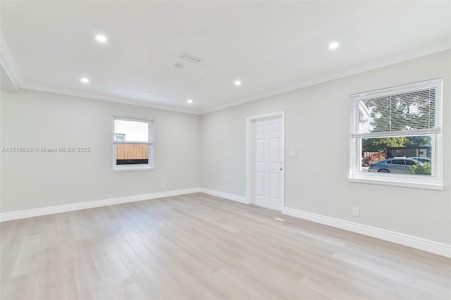 spare room with light wood finished floors, baseboards, crown molding, and recessed lighting