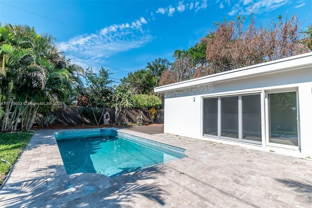 view of swimming pool featuring a patio area, fence, and a fenced in pool