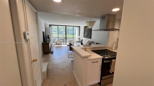 kitchen featuring sink, white cabinetry, island exhaust hood, and appliances with stainless steel finishes