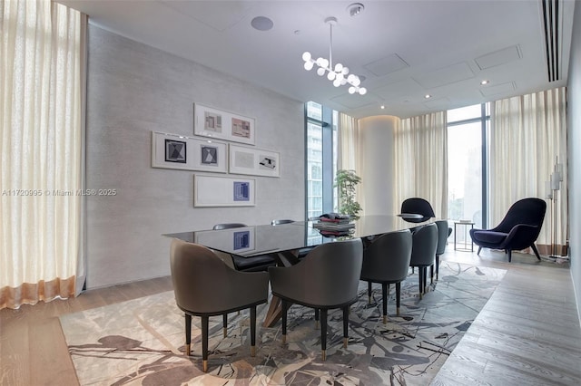 dining area featuring expansive windows and light wood-type flooring