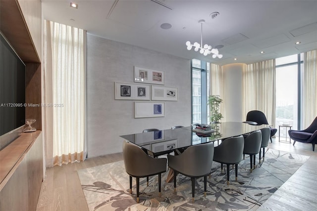 dining room with floor to ceiling windows and light wood-type flooring