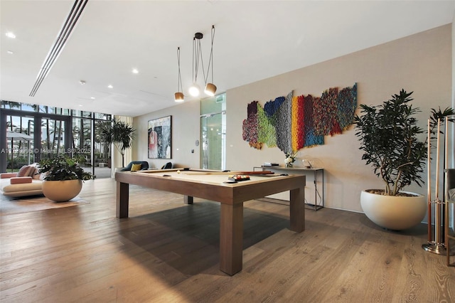 playroom featuring billiards, wood-type flooring, and a wall of windows