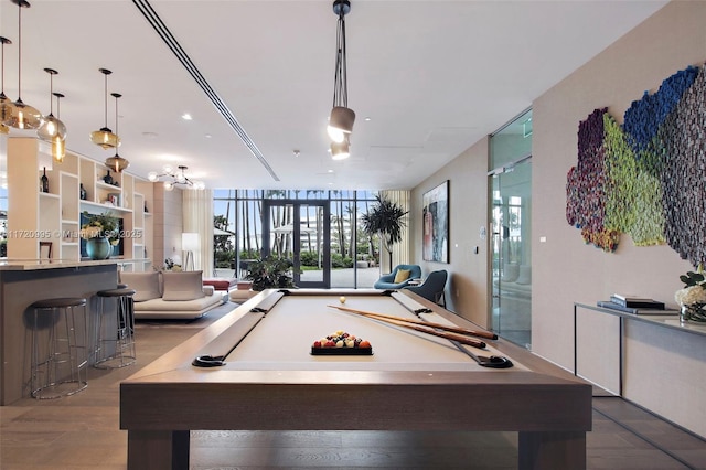 rec room with floor to ceiling windows, hardwood / wood-style floors, and billiards