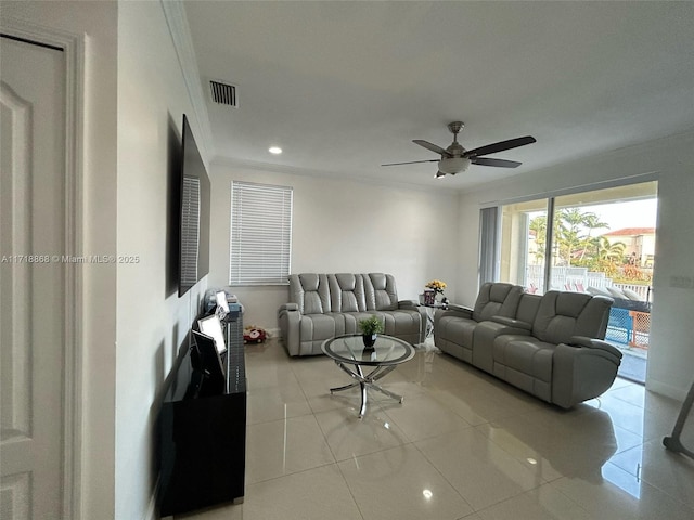 living room featuring ceiling fan, ornamental molding, and light tile patterned flooring