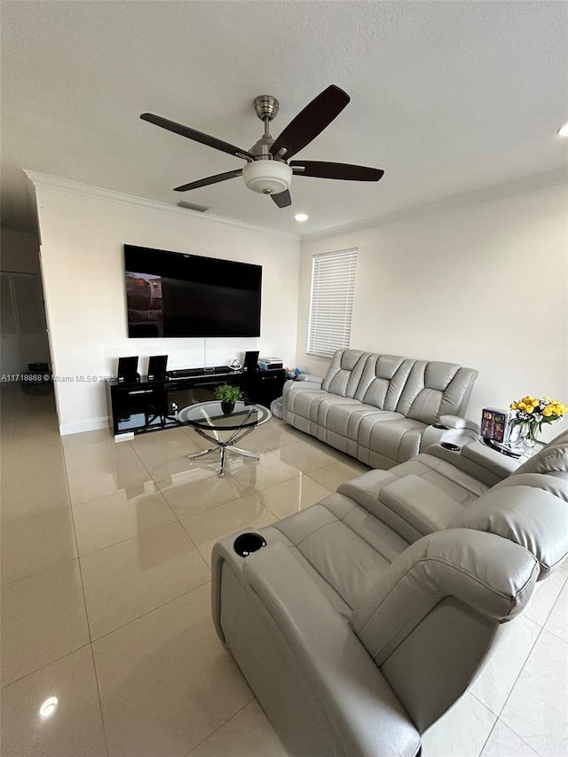 living room with light tile patterned floors, ceiling fan, and ornamental molding