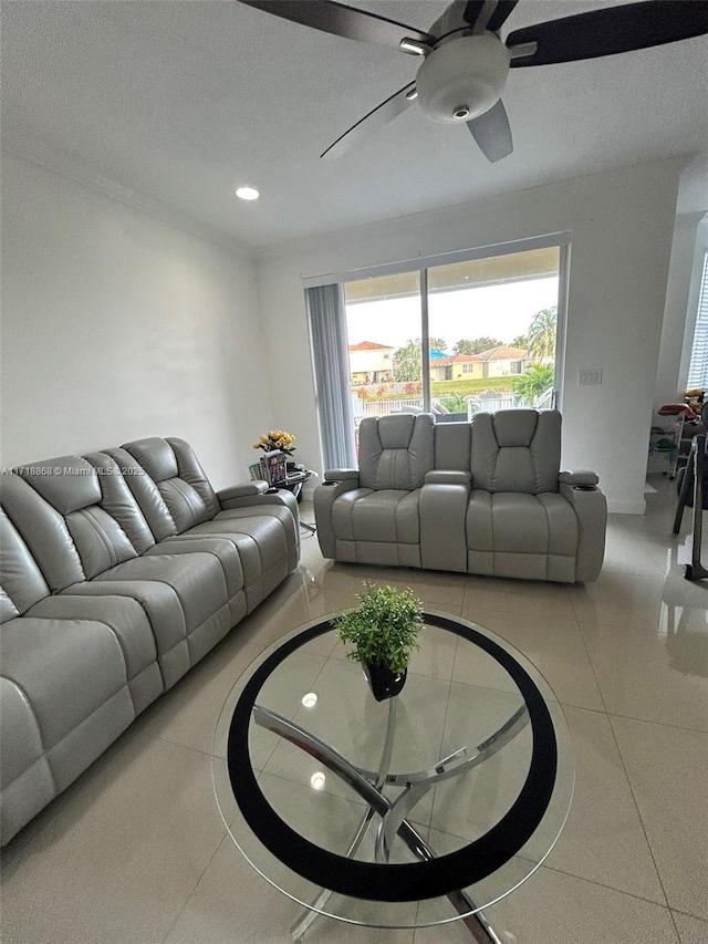 tiled living room featuring ceiling fan and ornamental molding