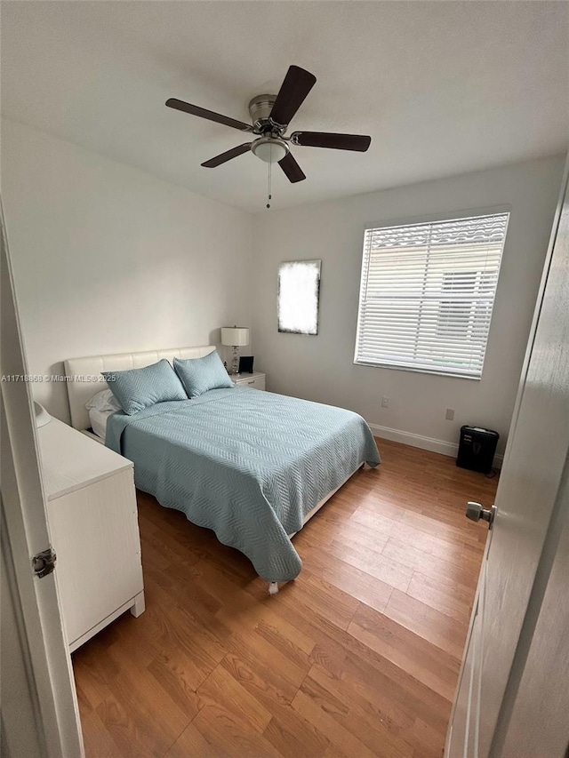 bedroom featuring light hardwood / wood-style flooring and ceiling fan