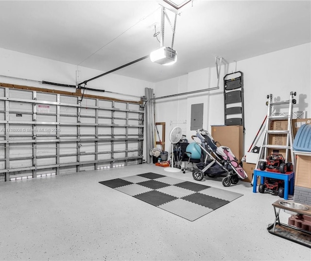 garage featuring electric panel and a garage door opener