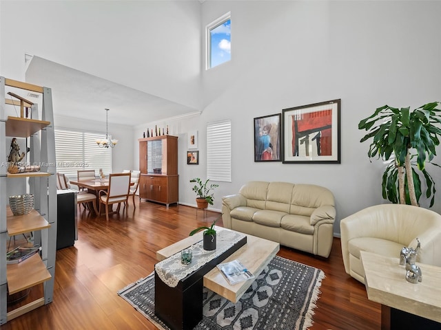 living room with a chandelier, plenty of natural light, and dark wood-type flooring