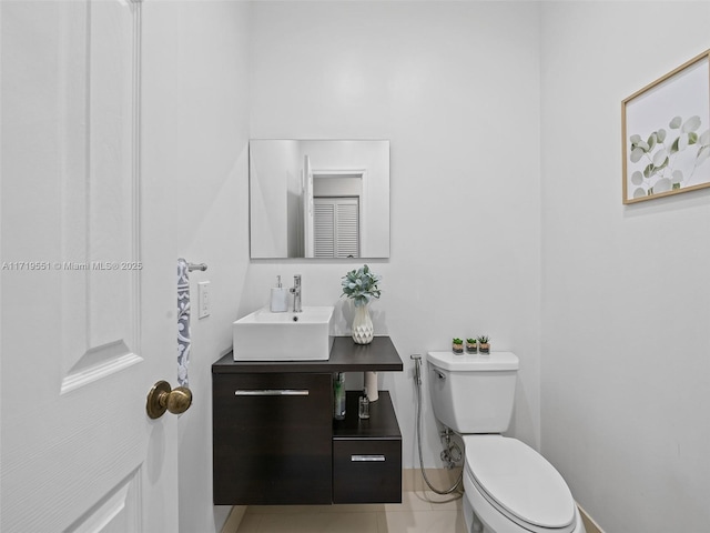 bathroom with tile patterned floors, vanity, and toilet