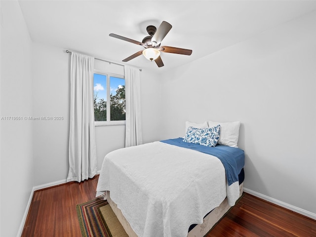 bedroom with ceiling fan and dark wood-type flooring