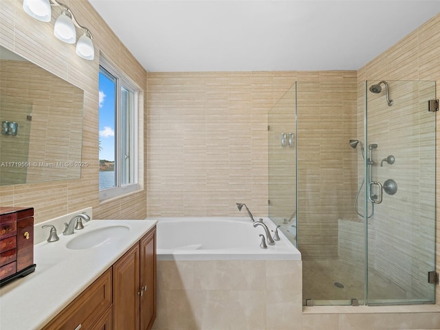 bathroom featuring vanity and independent shower and bath