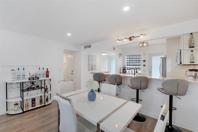 dining room featuring light hardwood / wood-style floors and sink