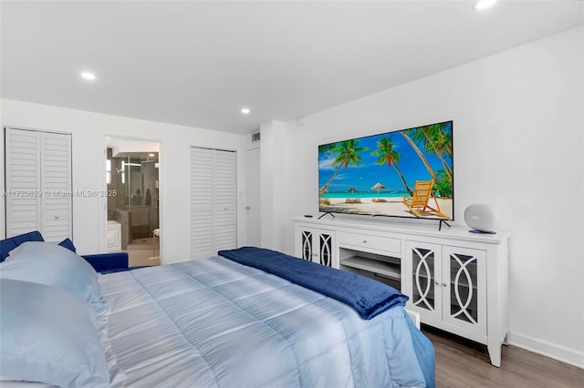 bedroom with hardwood / wood-style floors and ensuite bath