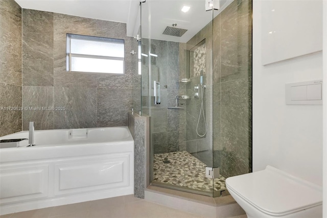 bathroom featuring toilet, shower with separate bathtub, and tile patterned floors