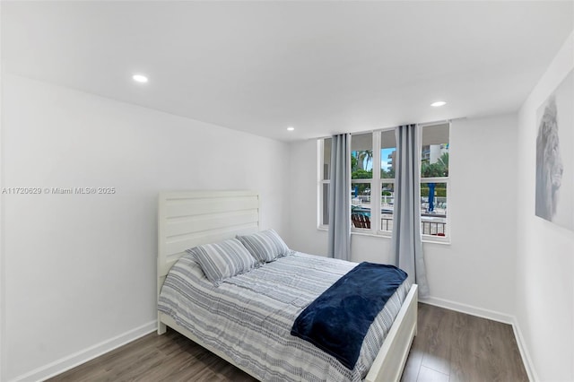 bedroom with dark wood-type flooring