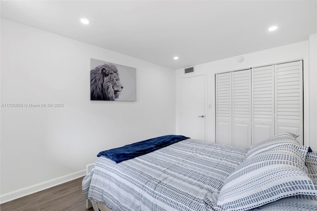 bedroom featuring a closet and dark hardwood / wood-style floors