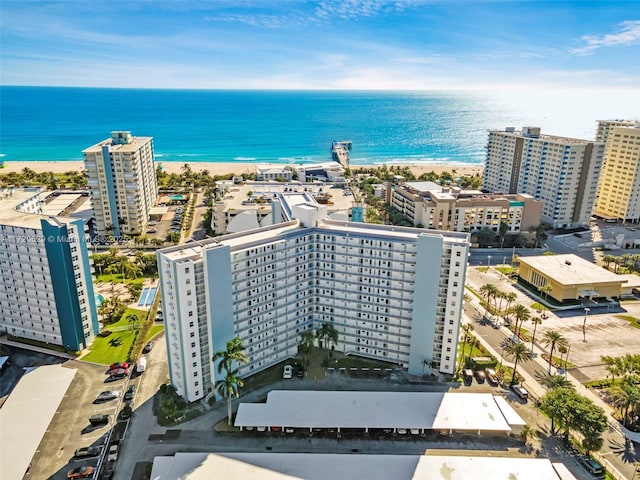 drone / aerial view featuring a beach view and a water view