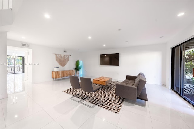 living room with a wealth of natural light and light tile patterned floors