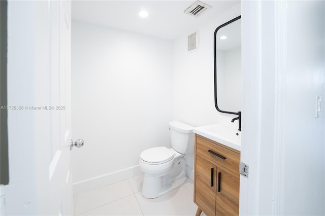 bathroom featuring tile patterned flooring, vanity, and toilet