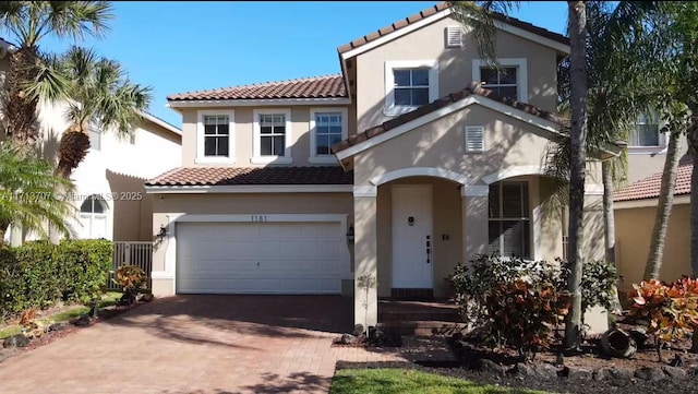 mediterranean / spanish home featuring a garage